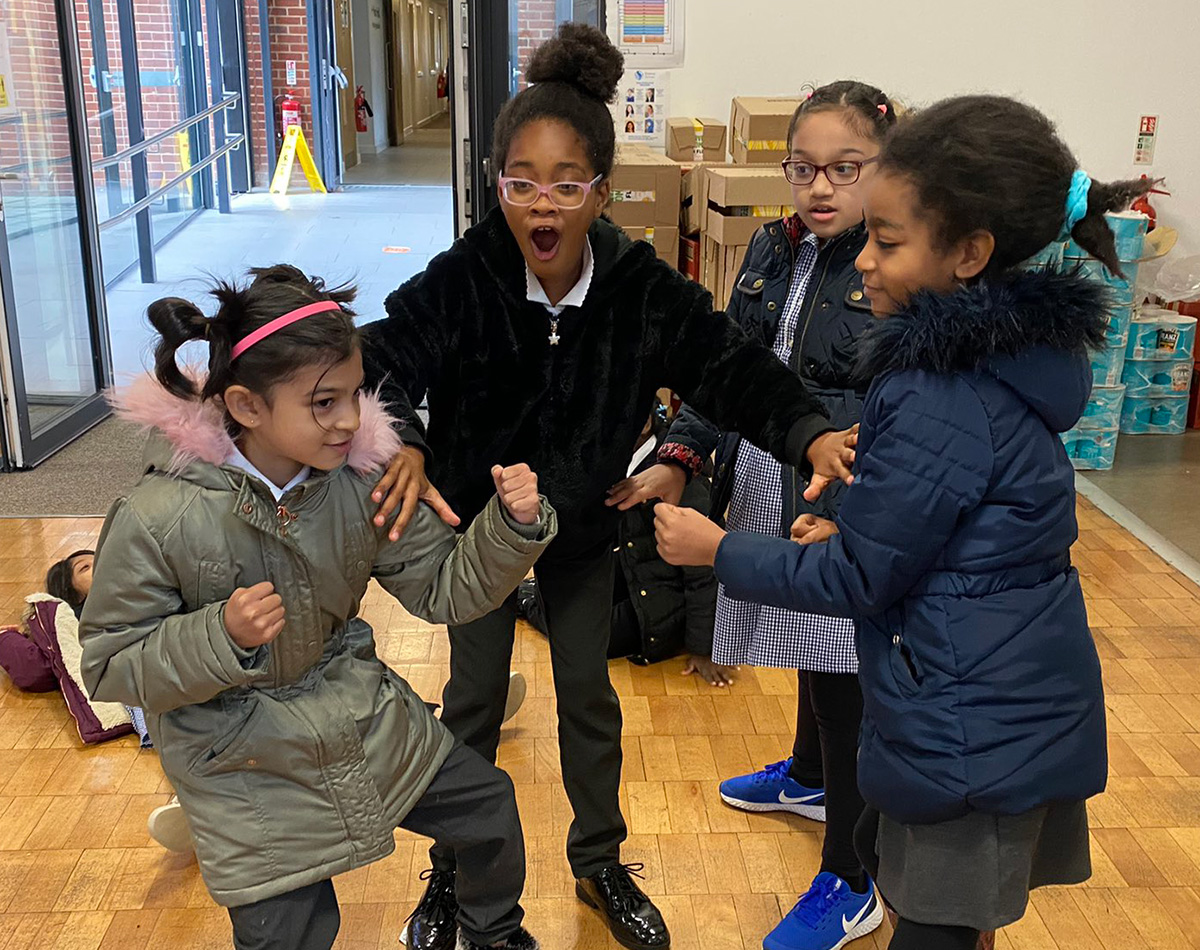 Primary school children perform a freeze frame in a Coram Shakespeare Schools Foundation workshop.